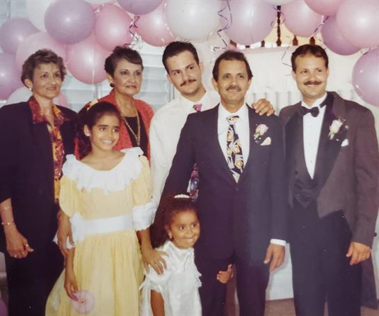 Guests smiled at a joyful family celebration adorned with decorations and balloons.