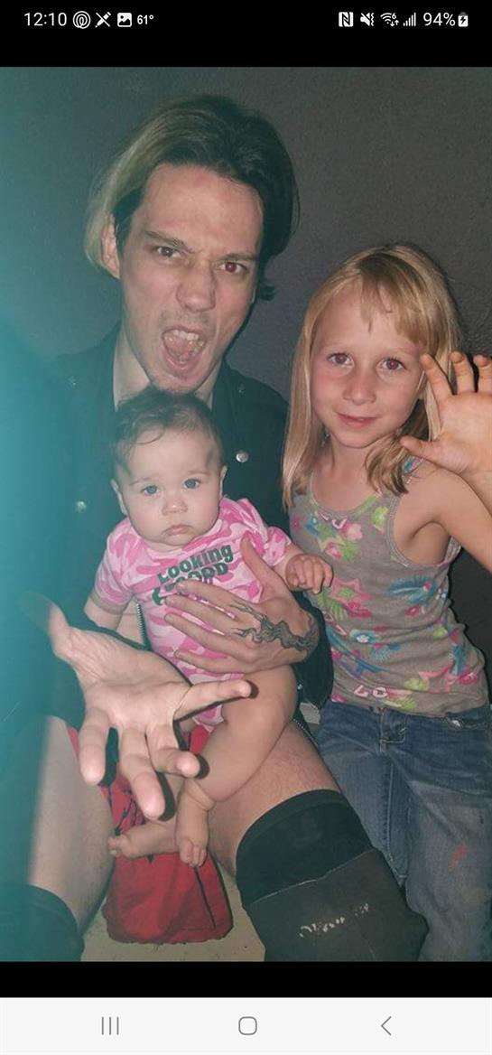 Parent shares a joyful moment with two kids, showcasing love and laughter in a playful environment.