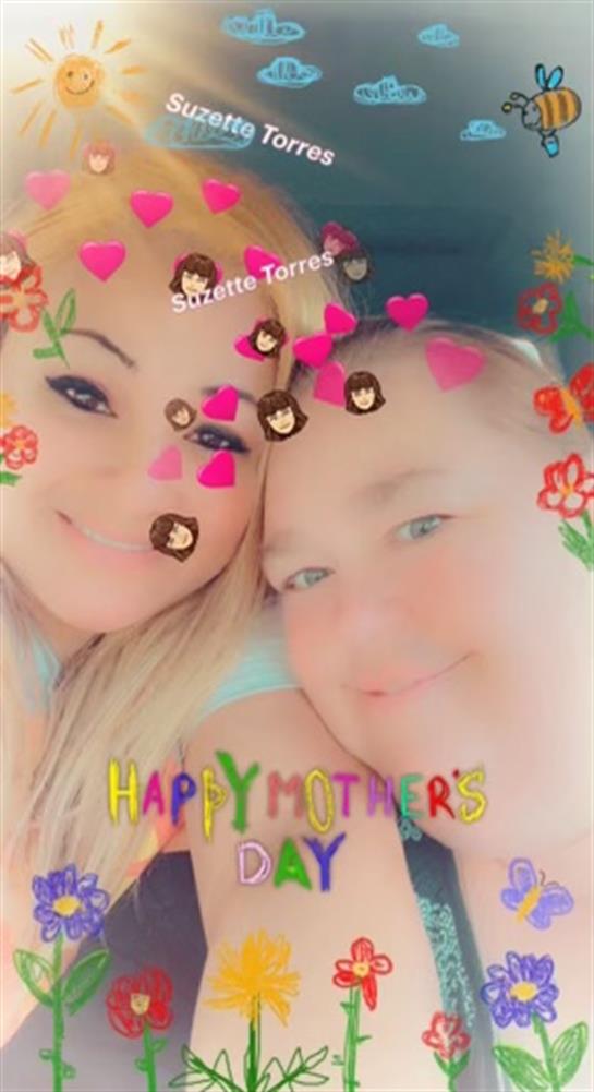 Two people joyfully celebrate love amidst heart and floral decorations.