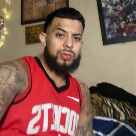 Person exudes style and confidence in a red jersey against a relaxed backdrop.