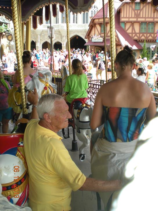 Families and friends gather at a carousel, sharing laughter and excitement at an amusement park.