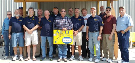 A diverse group of volunteers stands proudly, showcasing teamwork and community spirit.