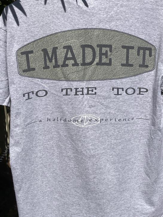 A gray t-shirt features the phrase I Made It To The Top, showcasing personal achievement.