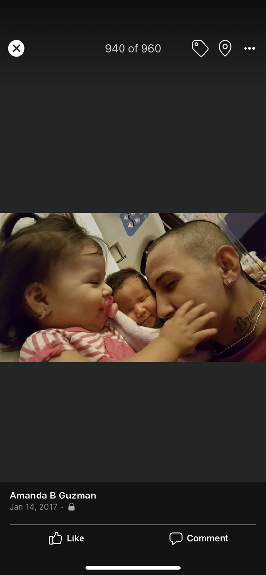 A father interacts lovingly with his two young children, eliciting joy and connection at home.