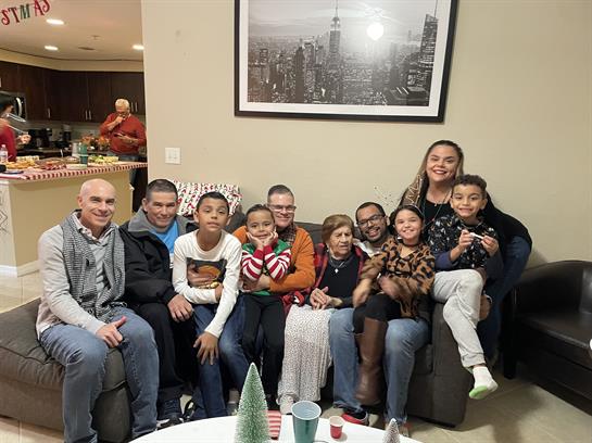 Friends and family celebrate together in a warm living room filled with laughter and joy.