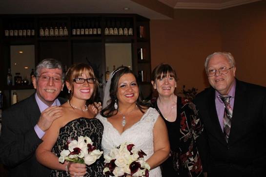 Wedding guests gather together with happiness and flowers in an elegant indoor venue.