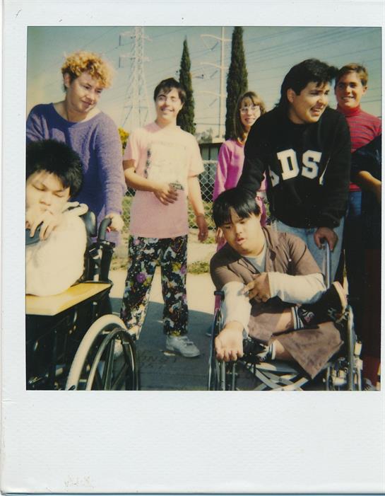 A group of young individuals engage in fun activities while smiling and interacting in a local park.