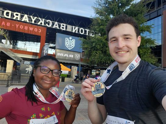 Two individuals show off their medals after completing a race in Arlington, Texas.