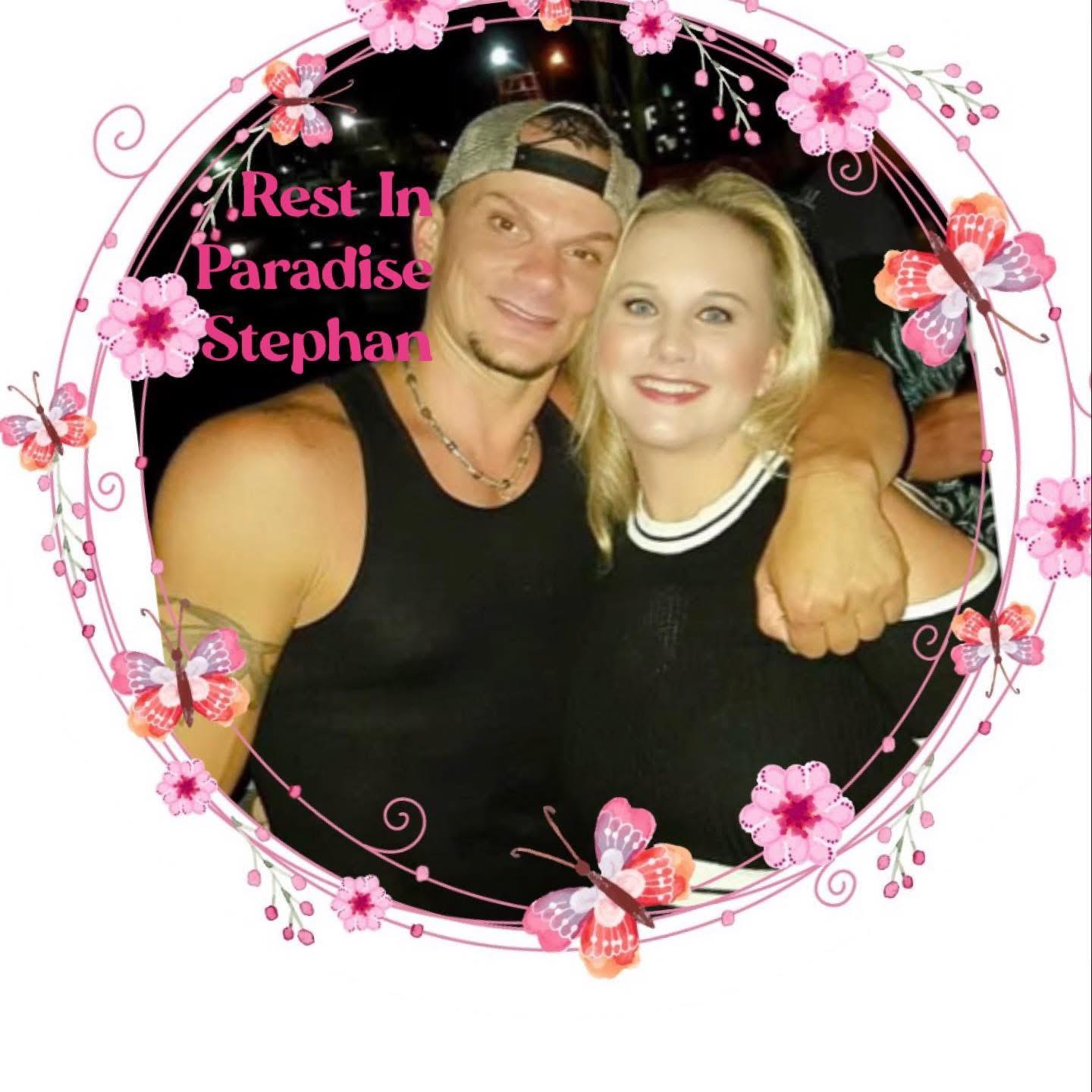 Two friends pose together in a lively atmosphere surrounded by flowers and cheerful decorations.