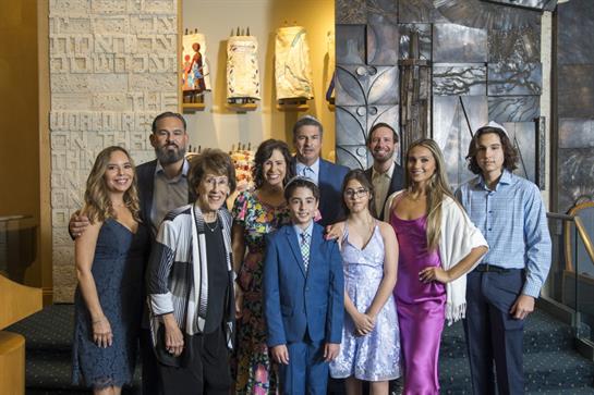 A diverse family celebrates together in a vibrant setting for a special occasion.