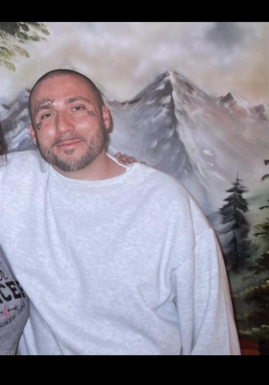 Two people are smiling and enjoying each other's company in a warm, inviting atmosphere.