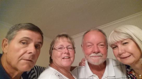 Family members enjoy a joyful moment together in a cozy living room, sharing laughter.