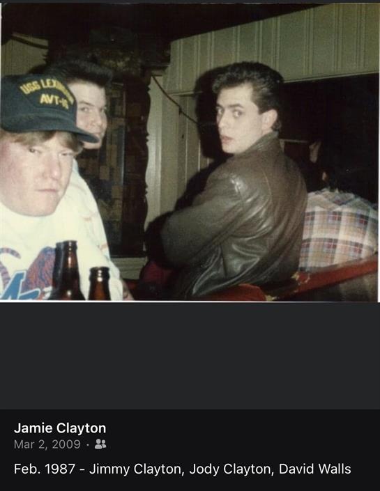 Friends gather at a bar, engaged in conversation, drinks in hand, enjoying the evening together.