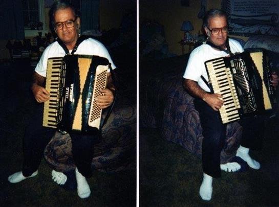Music fills the room as a man plays accordion while sitting on a couch at night.