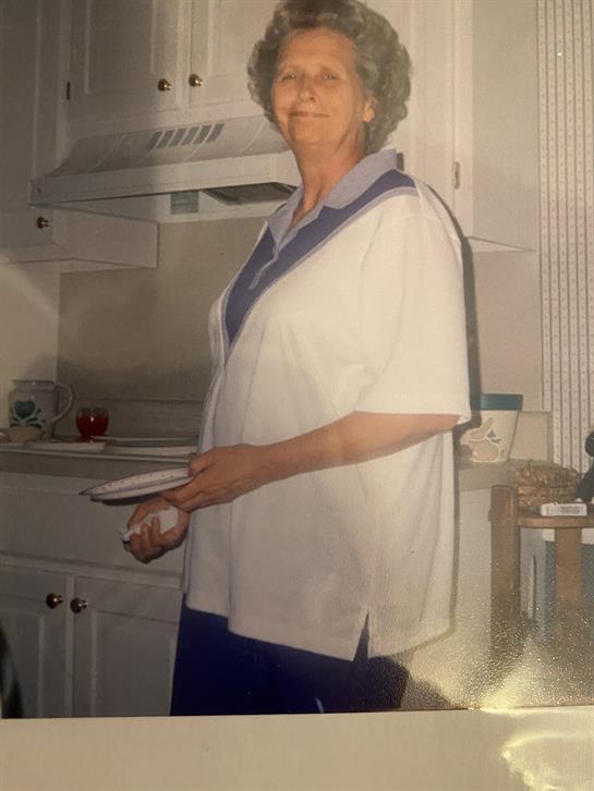 A woman in a white shirt holding a plate