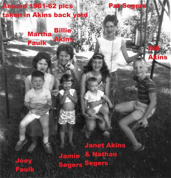 A family smiles and poses together in a sunny backyard in the early 1960s.