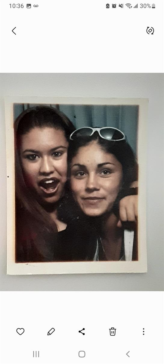 Two friends are joyfully posing with big smiles, showcasing their friendship and spontaneity.