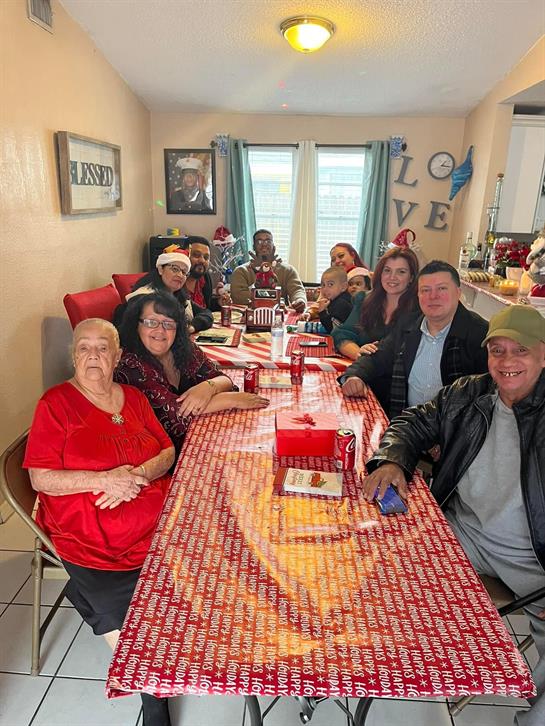 Group of family members enjoying a festive holiday meal together at home, smiling and celebrating.