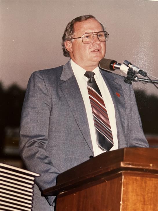 A man standing at a podium with a microphone