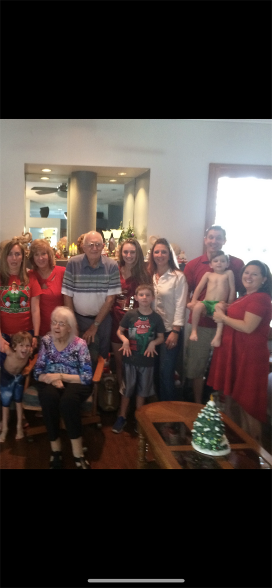 People share joyful moments together at a festive gathering in a warm, decorated space.