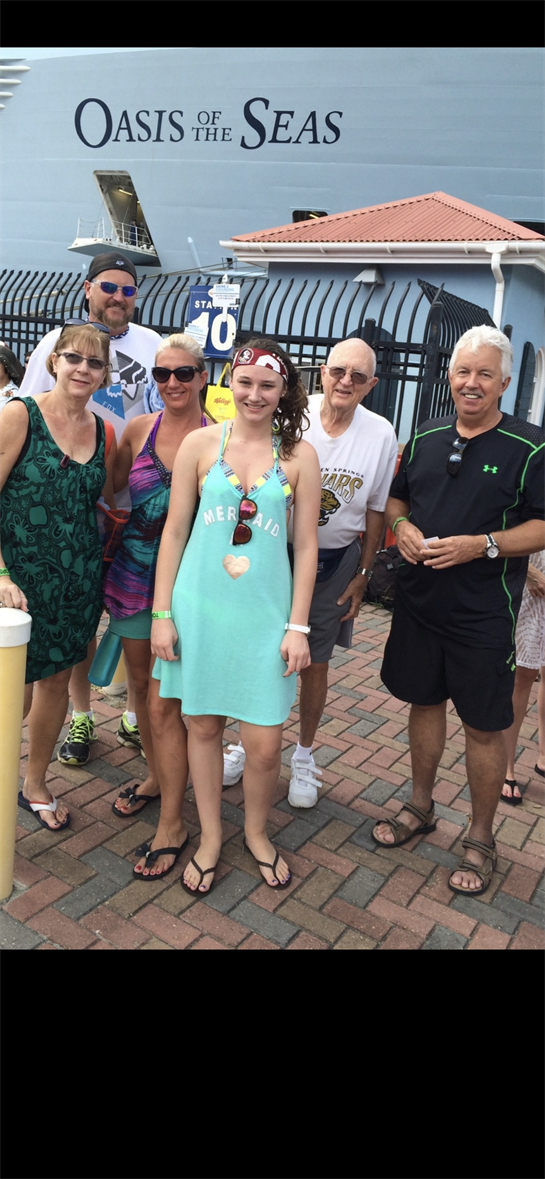 Five people gather together at a water park enjoying the lively atmosphere and summer fun.