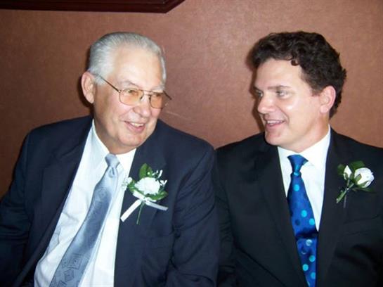 A man in suit and tie looking at another man
