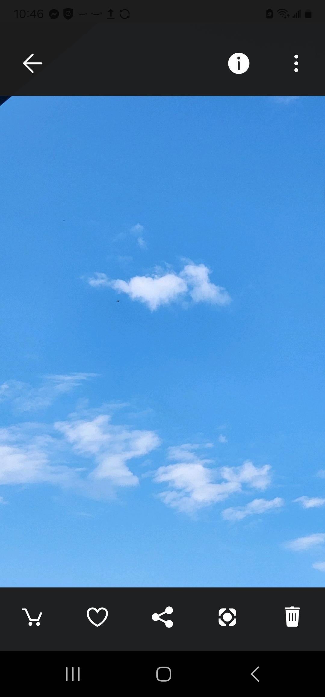 Clear blue sky with fluffy white clouds creating a peaceful atmosphere in midday sunlight.