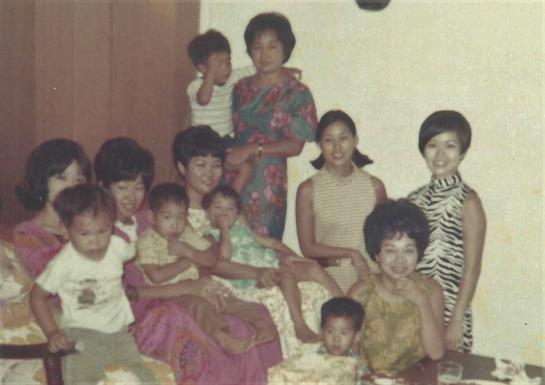 A joyful family gathering features multiple generations sharing laughter and stories together.