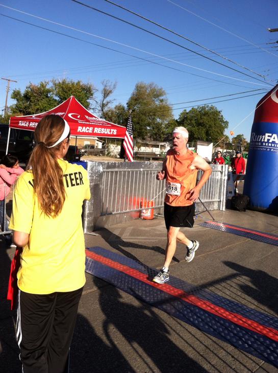 Racers finish strong as volunteers cheer and support them at the local event.