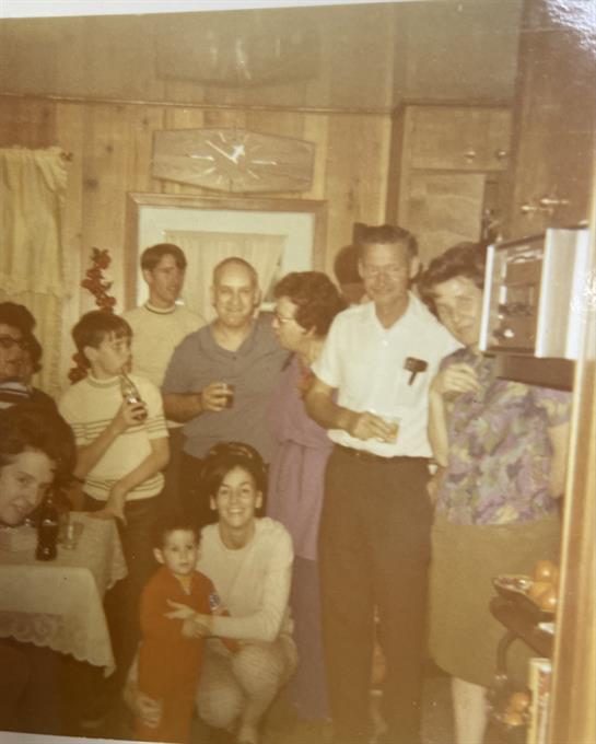 Friends and family enjoy a lively gathering in a warmly decorated living room.