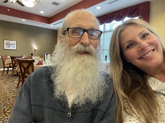 Two smiling individuals capture a joyful moment at a community center event focused on connection.