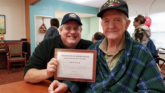 Celebration at a community center brings joy as veterans receive awards for their service.