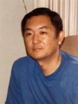 Individual appears relaxed while sitting indoors, engaging in thought or conversation.