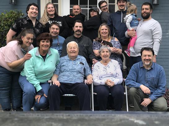 Family members gather in a backyard for a joyful reunion, celebrating togetherness and love.