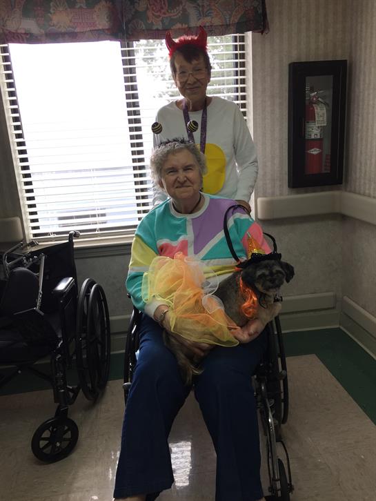 A woman in a wheelchair with a dog