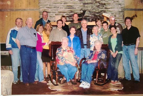 Friends and family gather joyfully in a cozy lodge setting, creating cherished memories together.