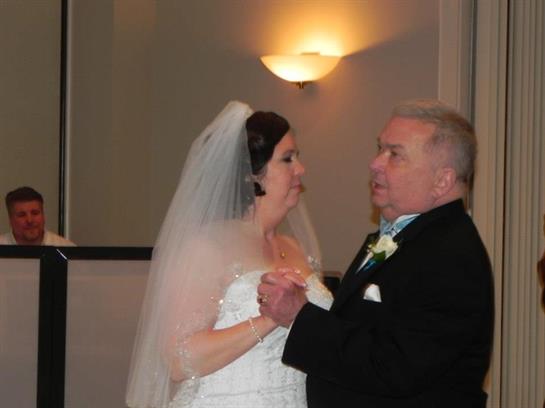 Newlyweds share their first dance in a beautifully lit and elegant venue.
