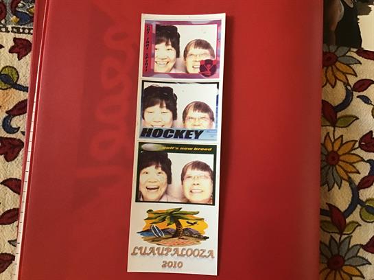 Two friends enjoy a playful session at a hockey event, with colorful booth pictures capturing joy.