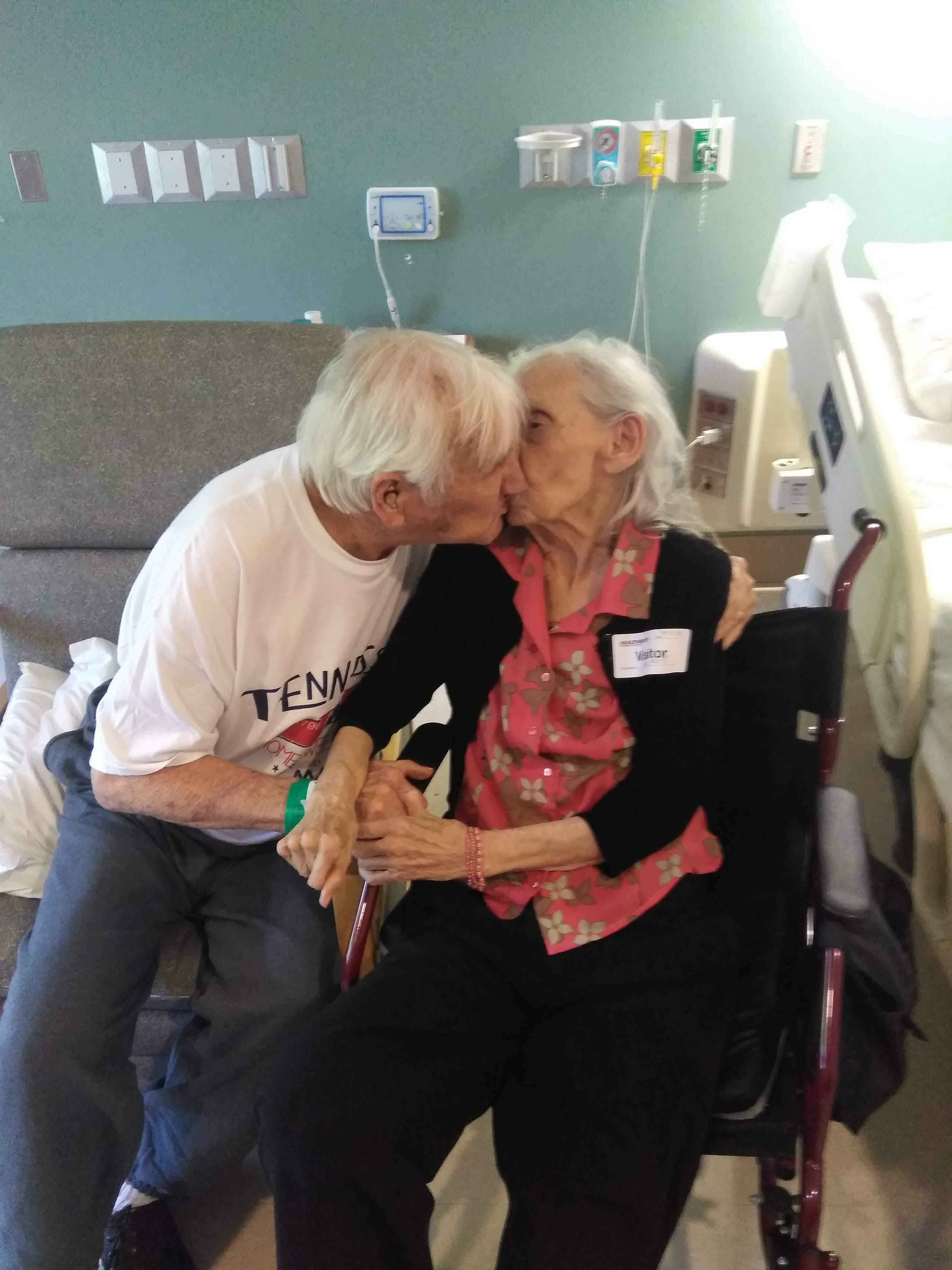 Love is timeless as an elderly couple shares a sweet kiss in a hospital room.