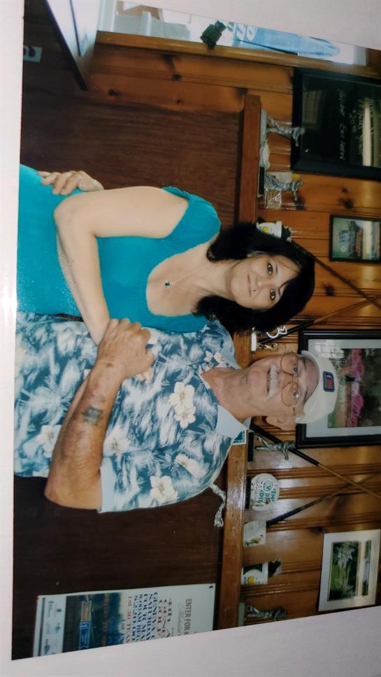 Two individuals sit closely together at a warm, inviting restaurant, sharing smiles and stories.