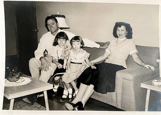 A cheerful family enjoys time together in their living room, creating a memorable moment.