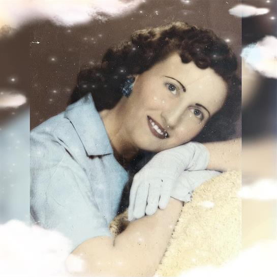 Vintage photo of a woman with curly hair, gloves, smiling in a dreamy setting.