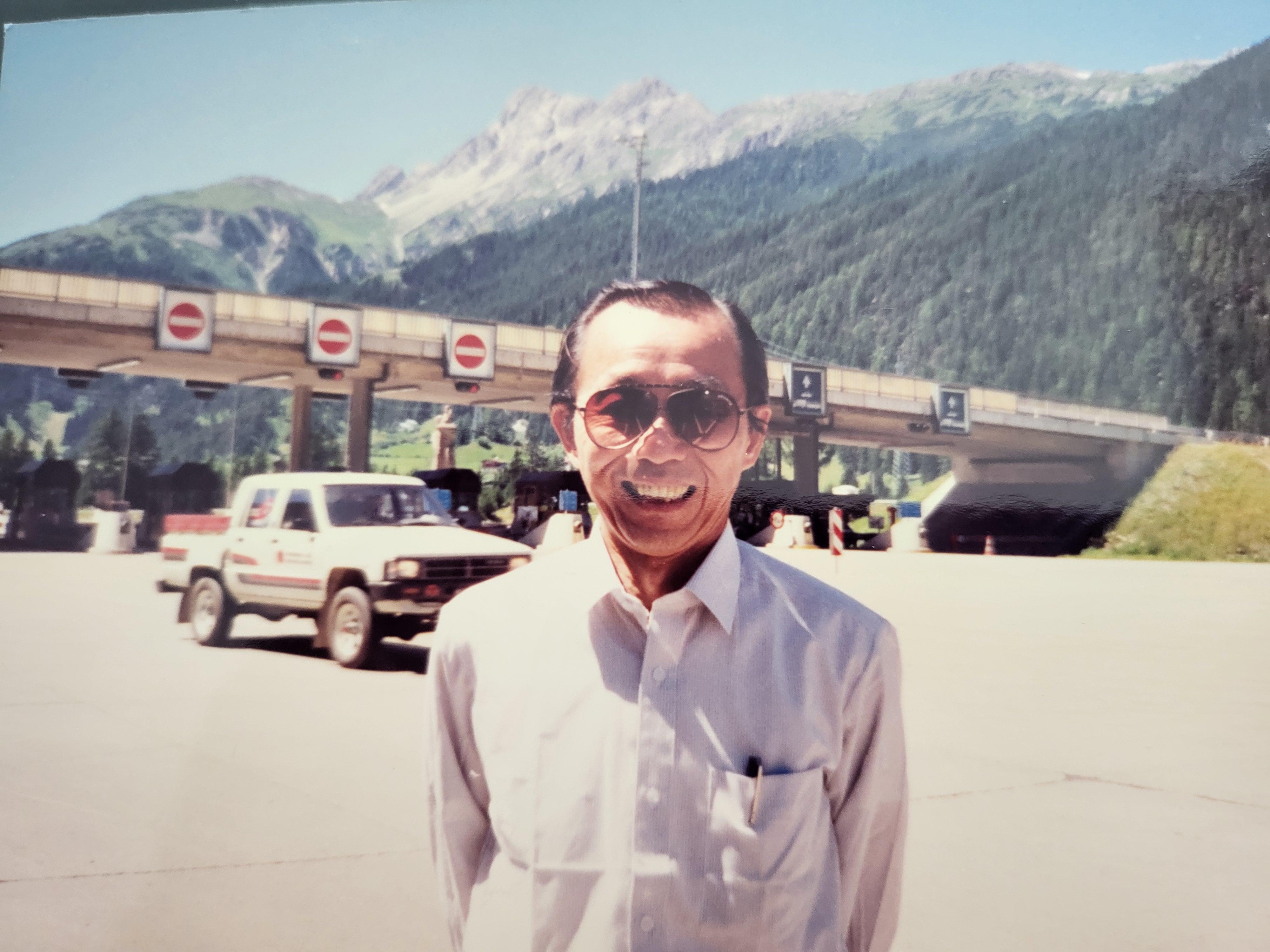 A man standing in front of a bridge