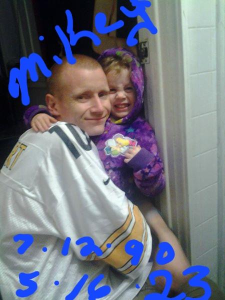 A joyful child hugs a man in a casual setting, highlighting affection and warmth.