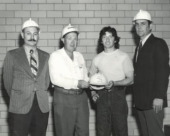 A group of men wearing hard hats
