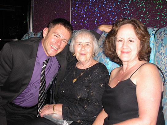 Voices filled with laughter as family members enjoy a joyous celebration in the evening.