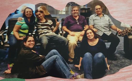 Group of friends seated together, sharing laughter and enjoying each other's company.