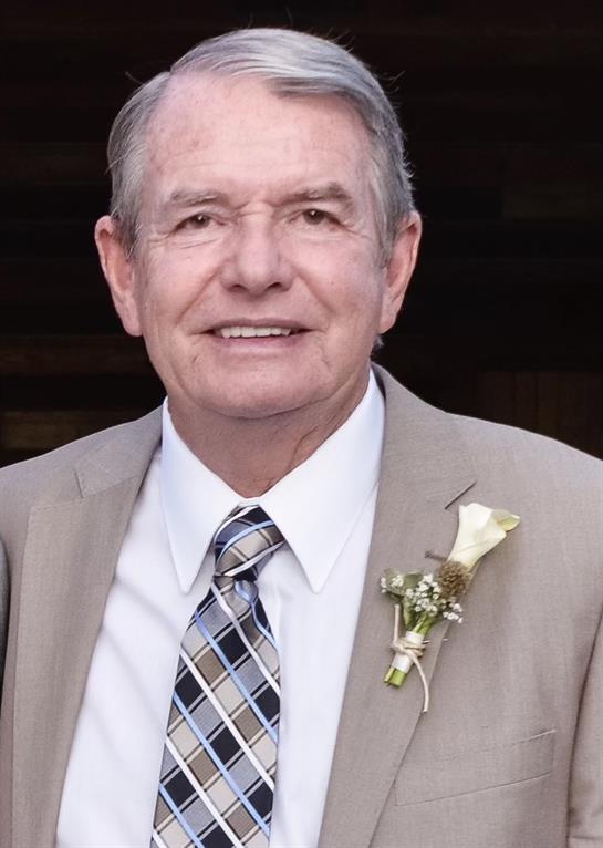 Joyful elderly man dressed in a suit with a flower boutonniere at a special event.