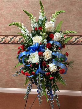 A bouquet of flowers with blue ribbon