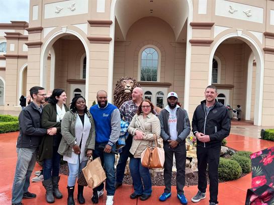 A group of people standing in front of a building